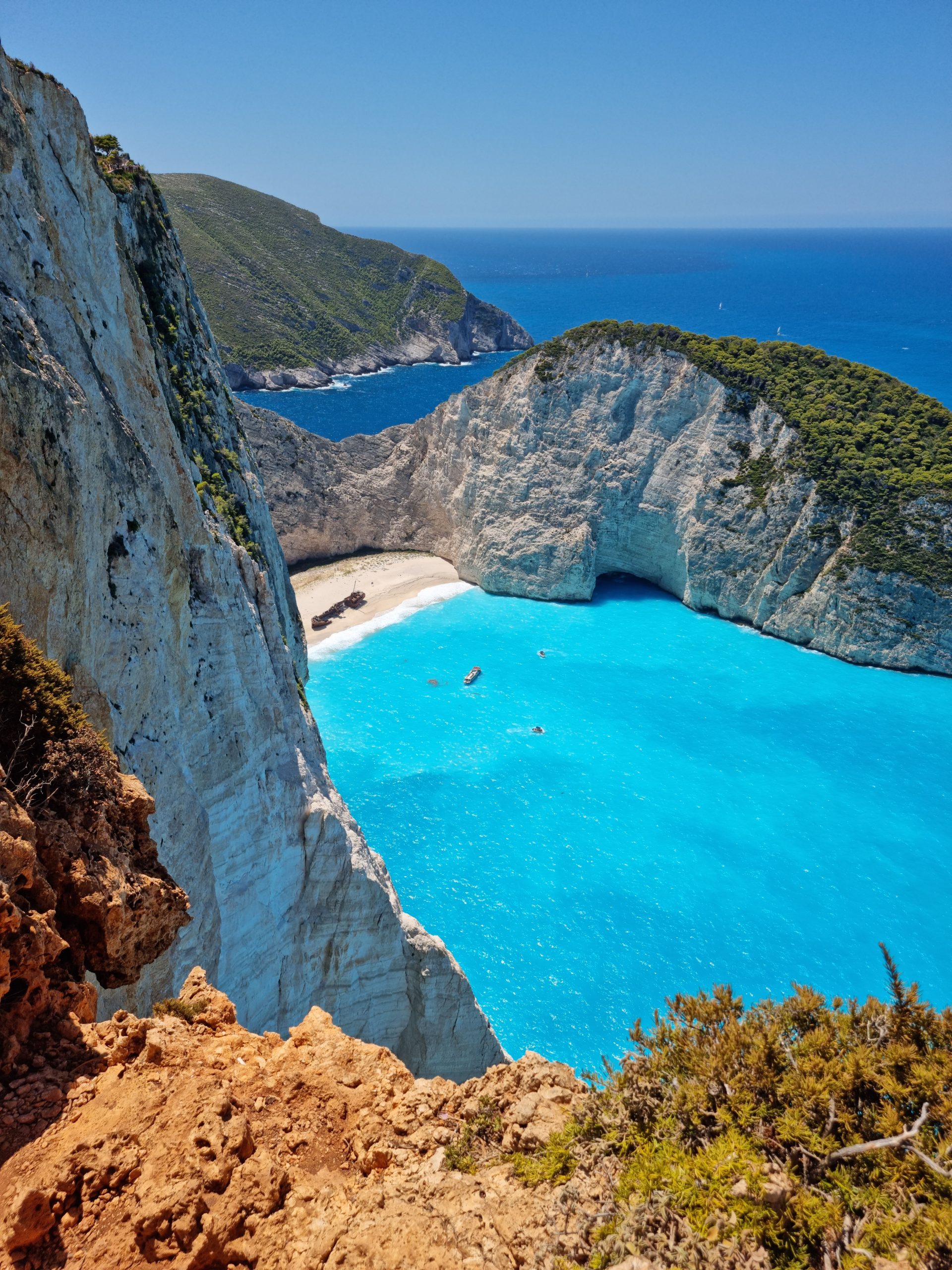 A stunning aerial shot of Navagio Beach, Zakynthos, with its turquoise waters and dramatic cliffs.